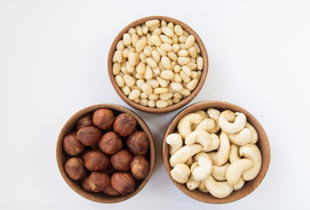 Three types of nuts in a round wooden form - Photo, Image