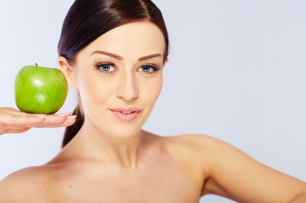 woman with a green apple - Фото, зображення