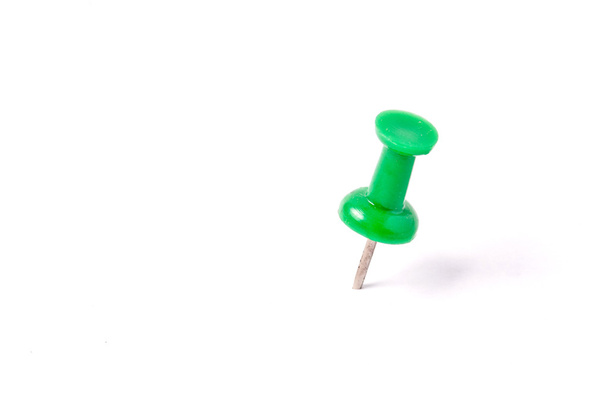 close up of a green pushpin on white background - Photo, Image