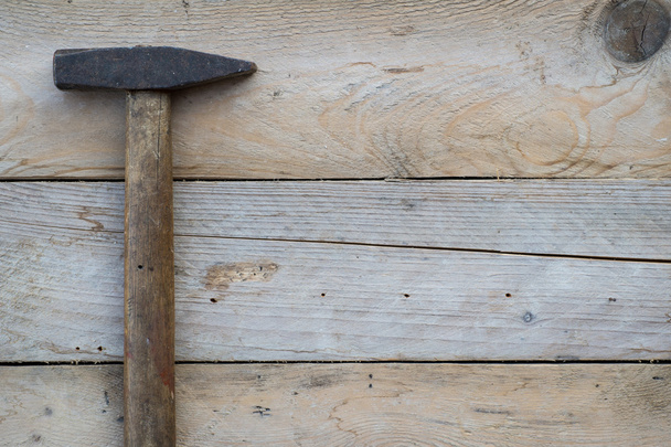 Wooden background with a hammer, home improvement concept - Valokuva, kuva