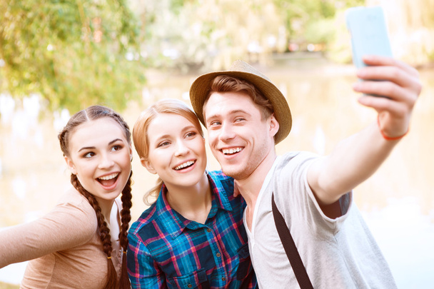 Three young people doing selfie in park - Foto, afbeelding