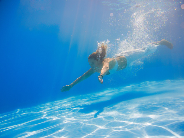 Young woman swimming undewater - Zdjęcie, obraz