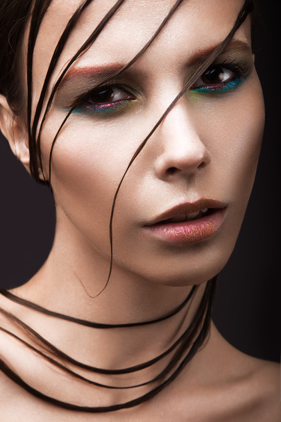 Beautiful girl with a bright colored makeup, wet hair and skin. Beauty face. - Fotoğraf, Görsel