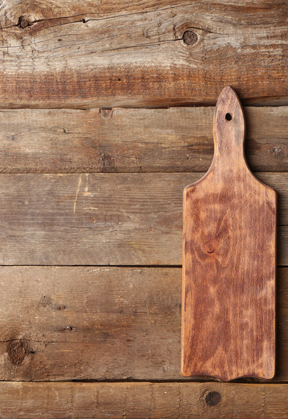 Cutting board on wooden background - Фото, изображение