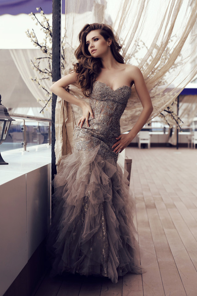 sensual woman with long dark hair in luxurious sequin dress  - Zdjęcie, obraz