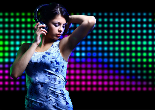 Portrait of a young dancing girl in headphones - Fotó, kép