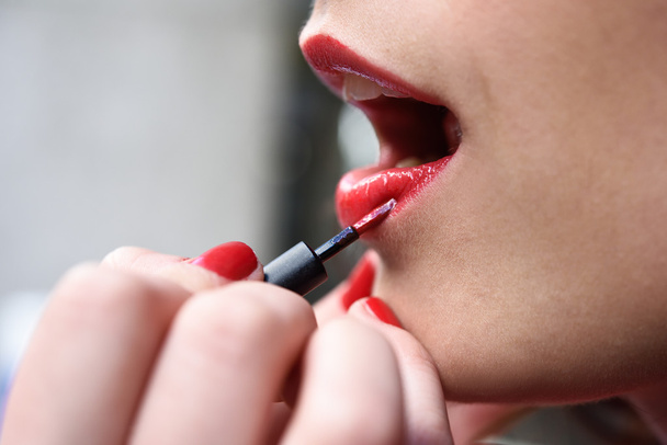 Attractive woman's mouth with fashion red lips makeup - 写真・画像