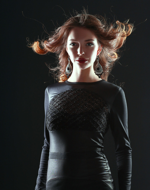 Portrait of beautiful brunette woman in black dress - Фото, зображення