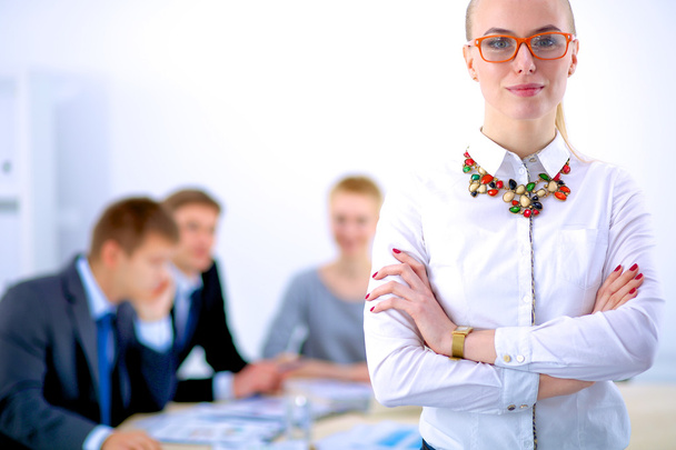 Portrait of a young woman working at office standing with folder - Foto, afbeelding