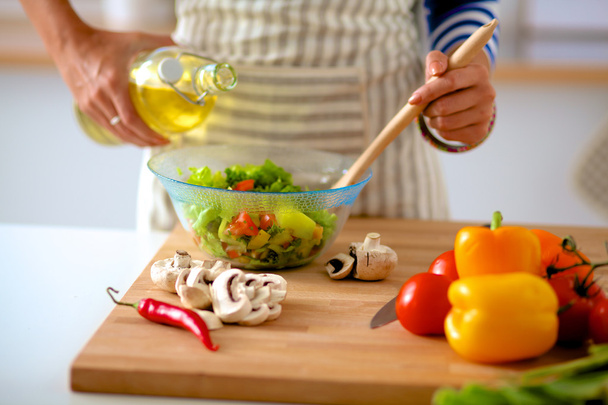 Young woman mixing fresh salad - Fotografie, Obrázek