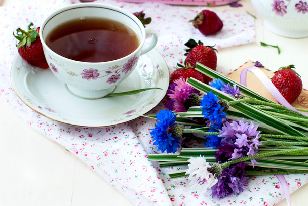 morning tea, strawberries and a bouquet of cornflowers - Photo, Image