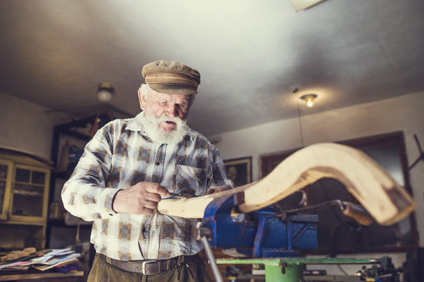 Senior craftsman working with planer - Foto, imagen
