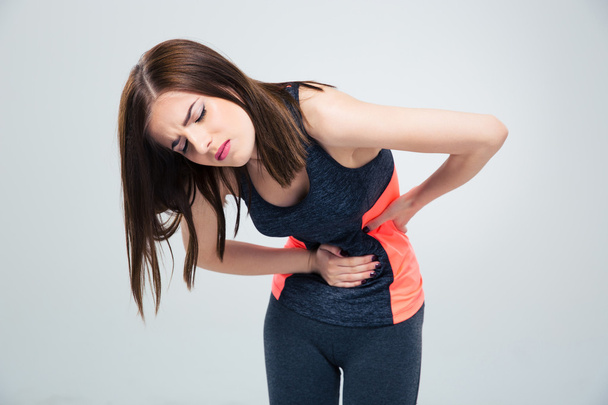 Fitness woman having pain in stomach - Photo, image