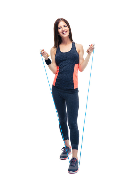 Sporty woman standing with jumping rope - 写真・画像