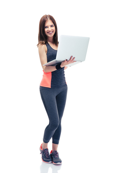 Happy fitness woman using laptop  - Fotoğraf, Görsel