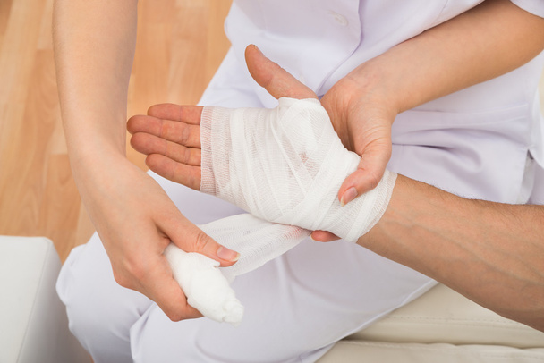 Doctor Bandaging Patient's Hand - Фото, зображення