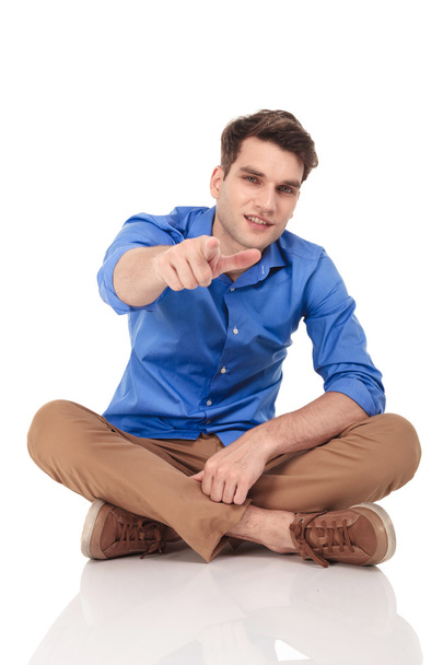 Young casual man pointing his finger at the camera. - Photo, Image