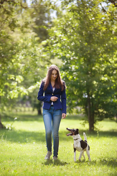 Young woman walking with her dog  - Fotoğraf, Görsel