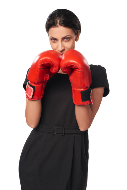 Serious business woman wearing boxing gloves - Foto, immagini