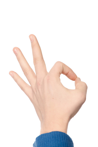 Hand in blue sweater showing OK sign isolated on white backgroun - Photo, image