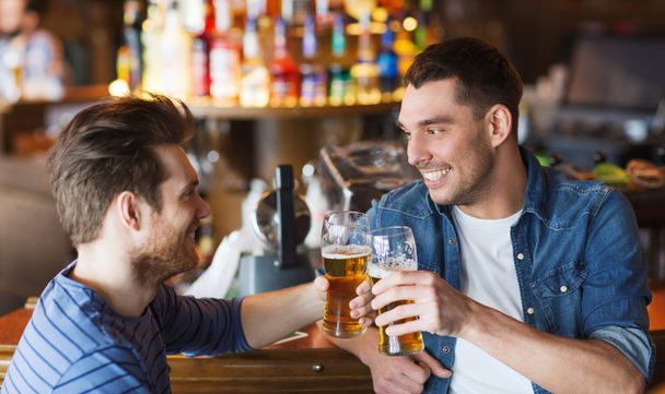 happy male friends drinking beer at bar or pub - Fotoğraf, Görsel