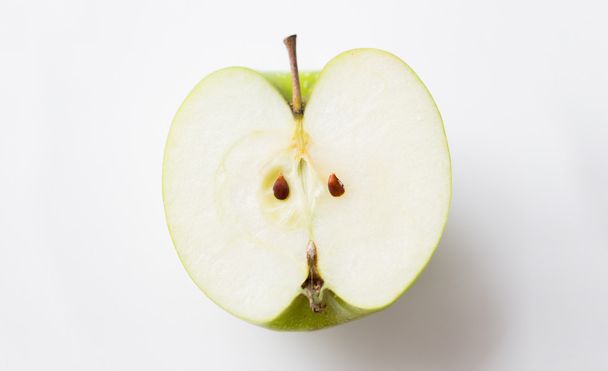 ripe green apple half over white - Fotó, kép