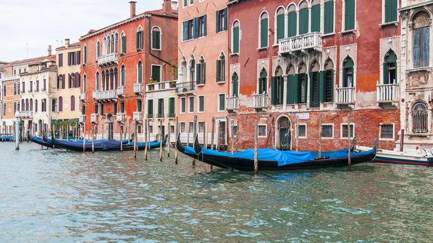 VENICE, ITALY - on APRIL 30, 2015. Typical urban view. The coast of the Grand channel (Canal Grande), the house on the coast and gondolas. The grand channel is the main transport artery of Venice and its most known channel - Photo, Image