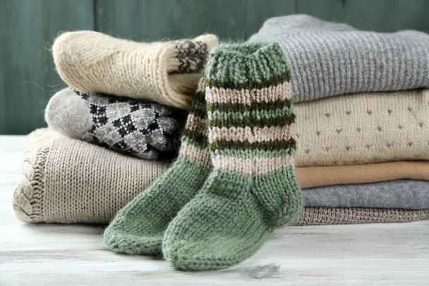 Knitting clothes on wooden background - Фото, зображення