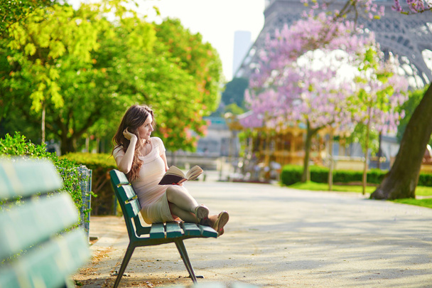 Beautiful woman in Paris, reading outdoors - Fotoğraf, Görsel