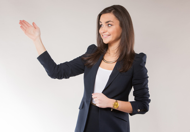 Young attractive businesswoman holding hand up - Photo, Image