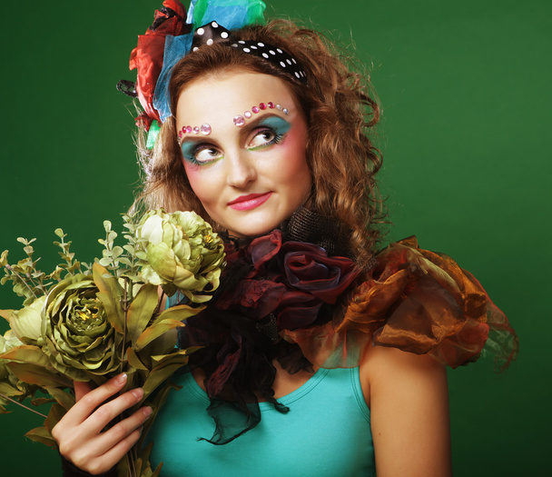 woman with brigt visage holding big green flowers - Foto, immagini