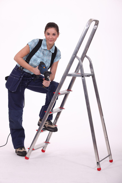 Female craftsman with drill and ladder - Foto, Imagem