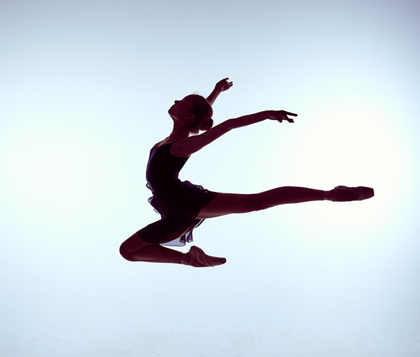 Beautiful young ballet dancer jumping on a gray background.  - Fotoğraf, Görsel
