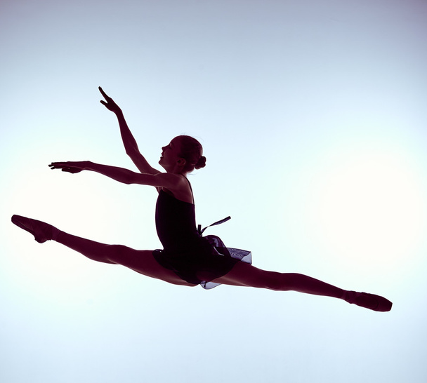 Beautiful young ballet dancer jumping on a gray background.  - Fotografie, Obrázek