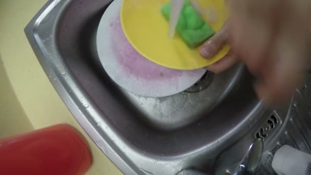 hand wash dirty dish sink with sponge. Camera hang on tap. 4K - Footage, Video