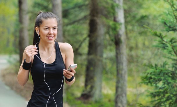 healthy lifestyle fitness sporty woman with headphone jogging in - Zdjęcie, obraz