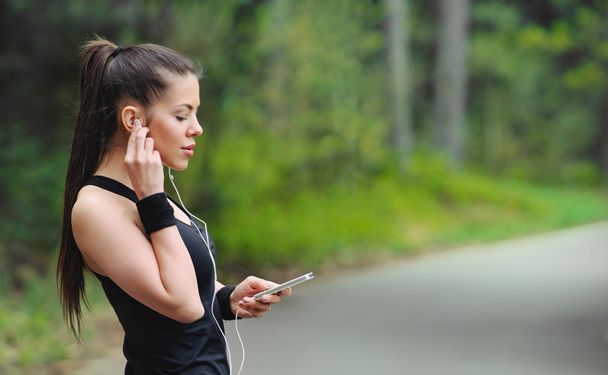 healthy lifestyle sporty woman with headphone jogging in beautif - 写真・画像