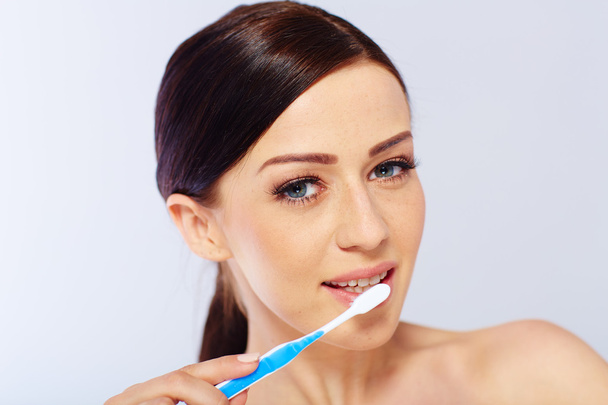 young woman with a toothbrush - Photo, image