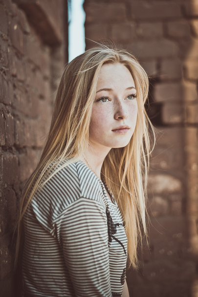 Portrait of the girl at a brick wall 2878. - Foto, Imagen