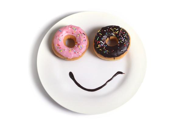 smiley happy face made on dish with donuts eyes and chocolate syrup as smile in sugar and sweet addiction nutrition - Photo, image