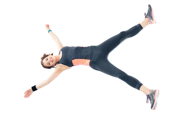 Beautiful happy fitness woman lying on the floor - Foto, immagini