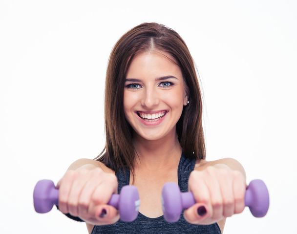 Happy young woman working out with dumbbells - Foto, immagini