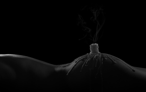 Body scape of woman with smoking candle and on her buttock artis - 写真・画像