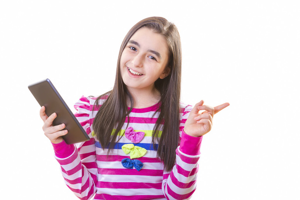 Beautiful teenager girl with digital tablet - 写真・画像