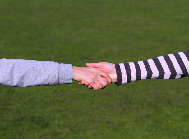 Closeup picture of teenagers shaking hands. - Photo, Image