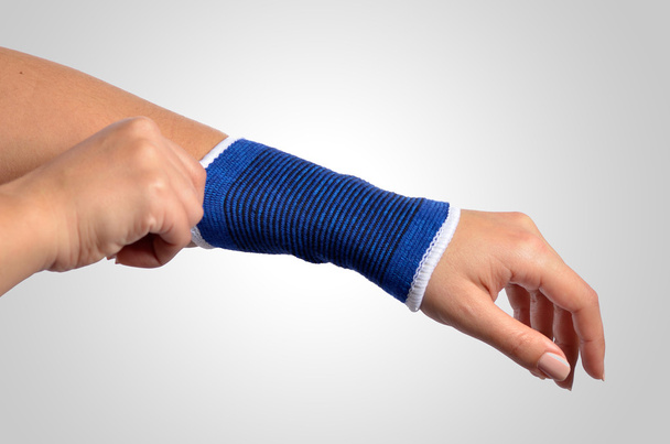hand with a orthopedic wrist brace - Foto, Bild