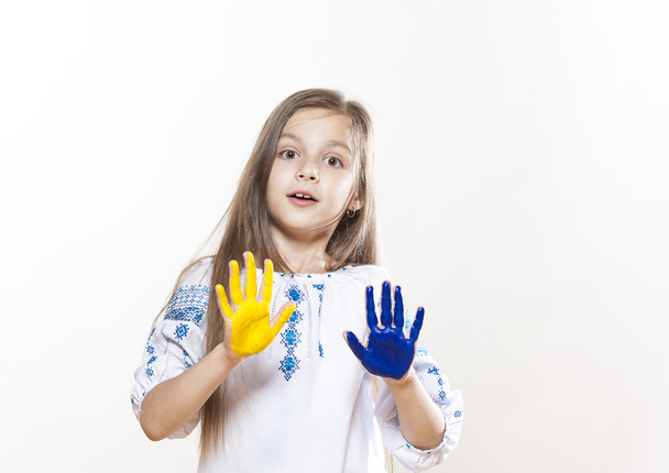Young girl in embroidery with hands yellow and blue colors - Фото, изображение