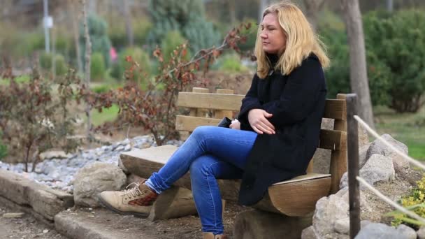 osamělý blond ženy sedící banku - Záběry, video