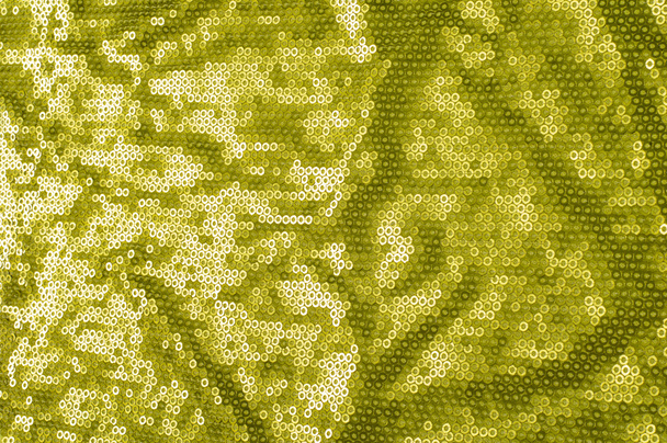 Fabric texture with green sequins. a small, shiny disk sewn as one of many onto clothing for decoration - Photo, Image
