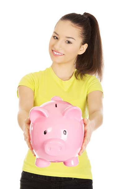 Happy woman holding piggybank. - Photo, Image